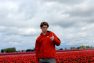 Zac the SEO lead in a tulip field giving a thumbs up