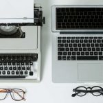 Content worfklow using github and markdown with a typewriter and laptop side by side