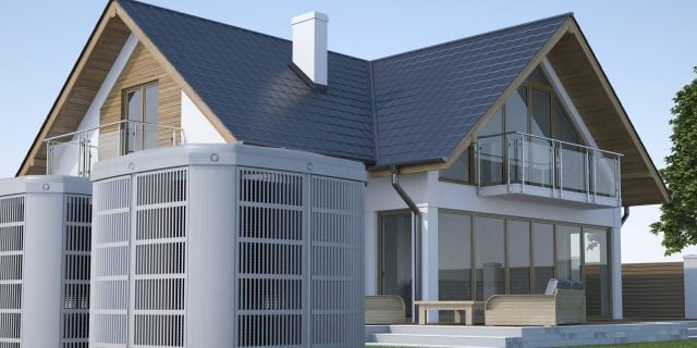 Image of a heat pump in the backyard with a suburban home in the background