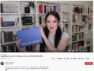 Screenshot of a YouTube video by "books with chloe" that is sponsored by Book of the Month. Chloe is holding up the blue Book of the Month box in front of her bookshelves.
